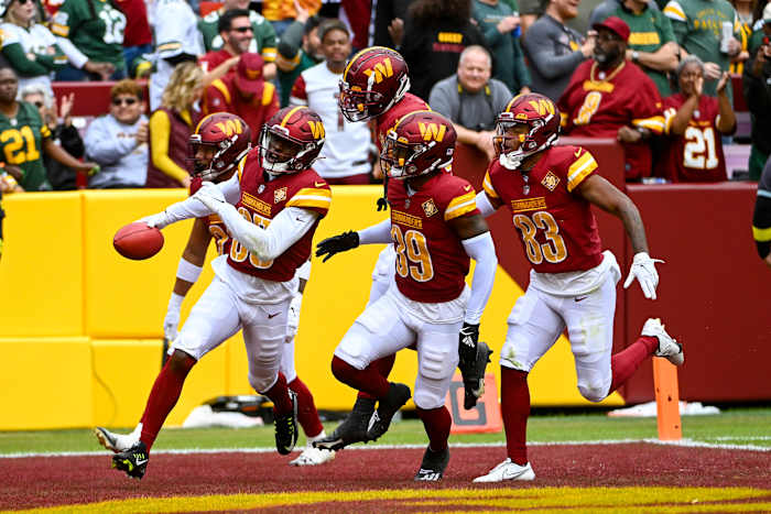 Percy Butler (35) of the Washington Commanders celebrates with teammates following the recovery of a muffed punt against the Green Bay Packers.
